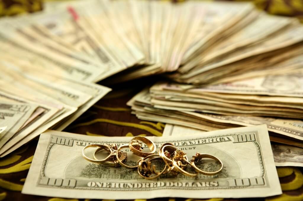 collection of rings on top of cash
