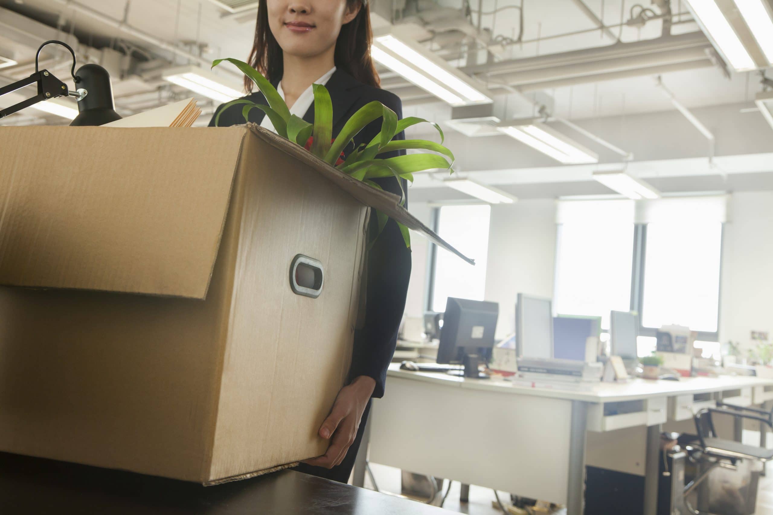 woman packing a box in an office