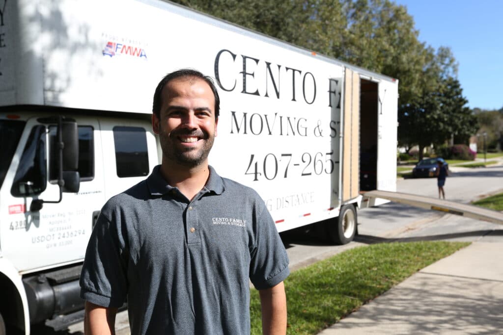 Felipe standing in front of the cento family moving and storage truck
