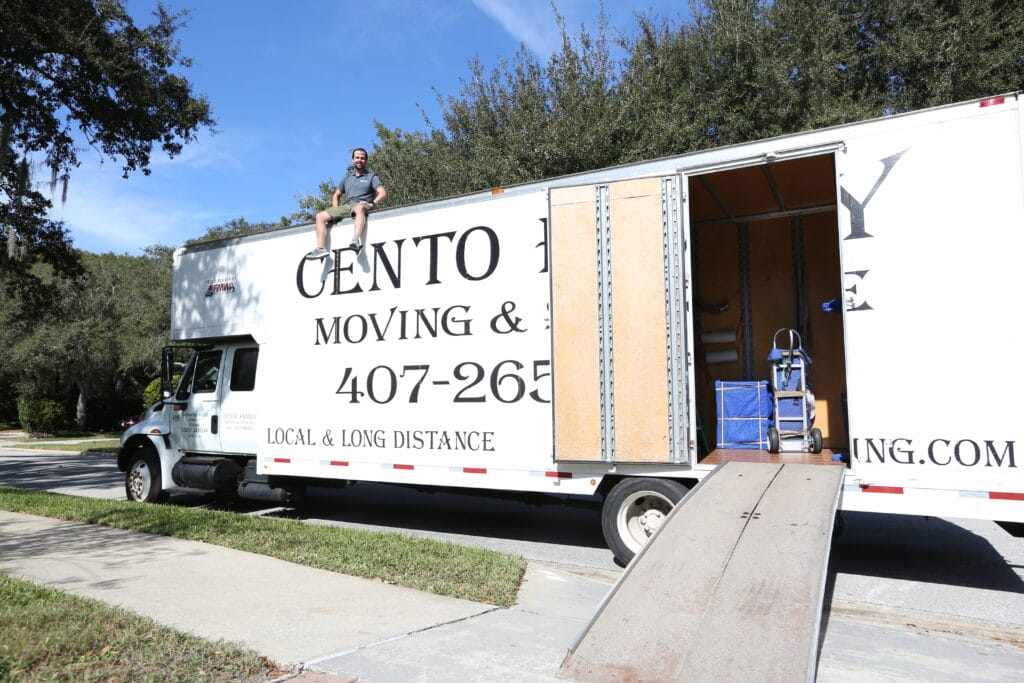 Felipe on top of the cento family moving truck