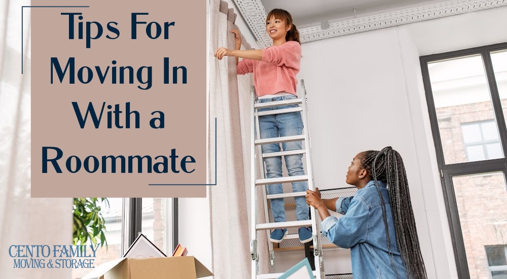 Tips For Moving In With a Roommate - two women hanging curtains in their new apartment