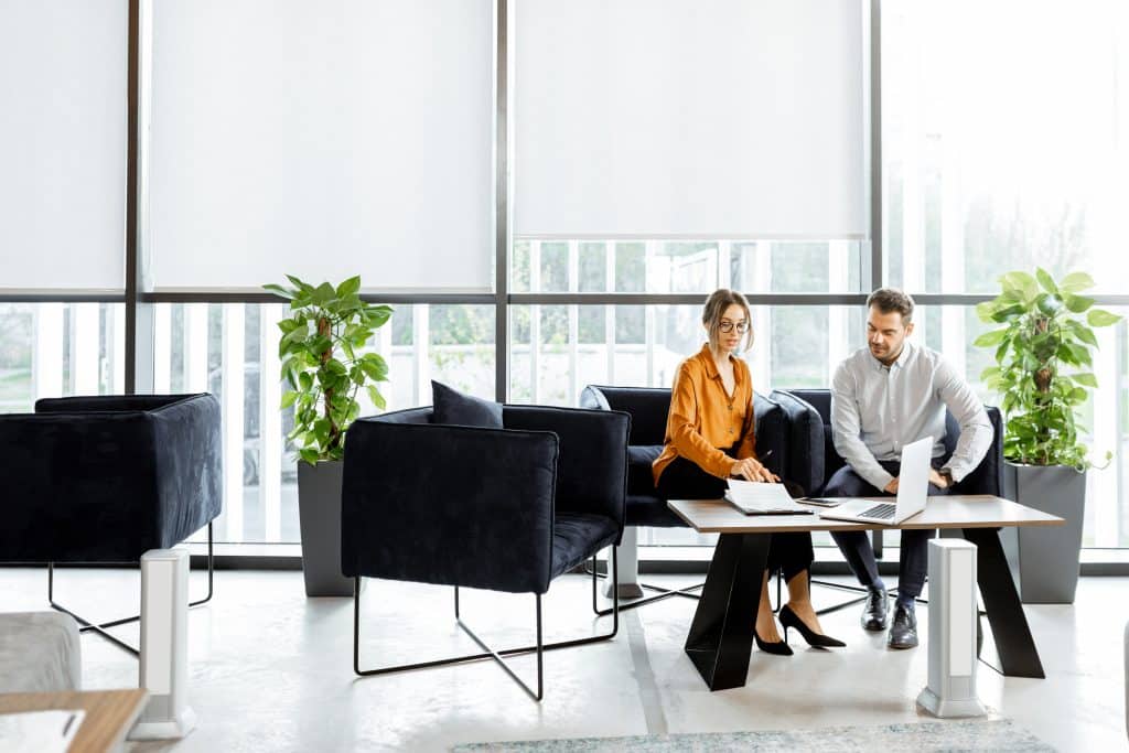 male and female employee collaborating in office lounge